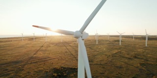 大型风力涡轮机叶片领域航拍明亮的日落蓝天风力发电厂