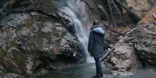 女人欣赏山间小瀑布