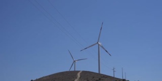 风力涡轮机在乡村山区景观中旋转