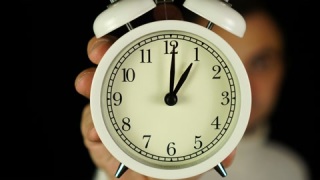 1点钟。人类手持闹钟，显示1点钟并响起。视频素材模板下载