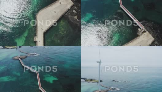 人们和风力涡轮机穿越清澈的海洋高清在线视频素材下载