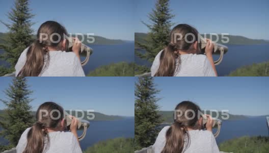 年轻女孩看双筒望远镜风景森林河流水树木山脉高清在线视频素材下载