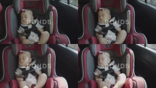 在家庭公路旅行中，快乐的亚洲婴儿睡在汽车座椅上。高清在线视频素材下载