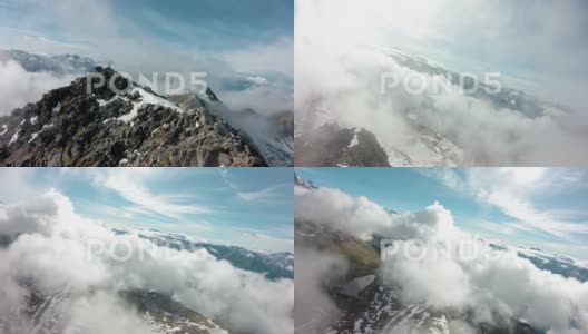 无人机飞越史诗般的山峰，用FPV无人机穿越云层高清在线视频素材下载