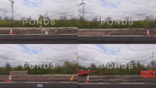 驾驶道路工程和风力涡轮机的路边视图高清在线视频素材下载