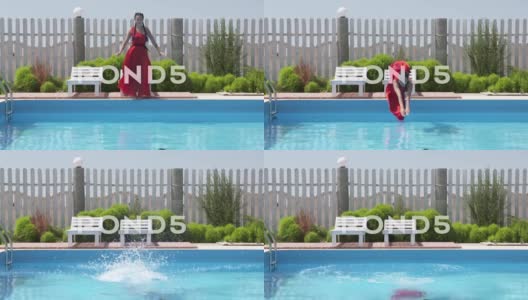 年轻女孩穿着长红裙子，慢动作跳入户外游泳池高清在线视频素材下载