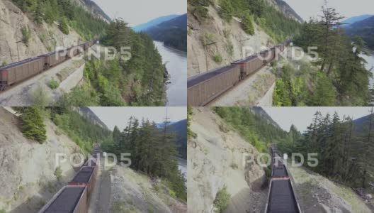 一列运煤火车穿过不列颠哥伦比亚省的一个河谷。高清在线视频素材下载