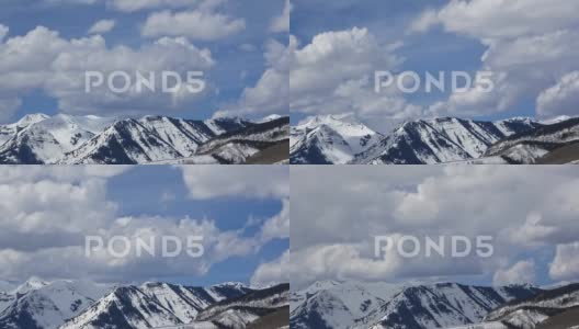 中午时分的雪山顶上云朵的时间流逝视频高清在线视频素材下载