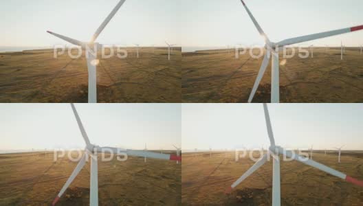 大型风力涡轮机叶片领域航拍明亮的日落蓝天风力发电厂高清在线视频素材下载