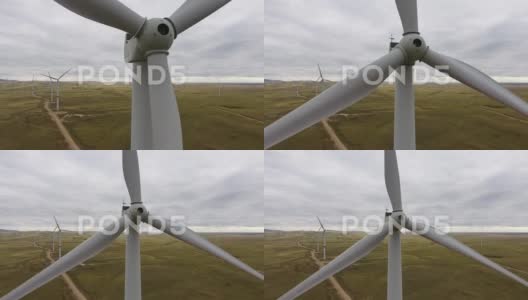 在田野背景下移动大型风力涡轮机的叶片高清在线视频素材下载