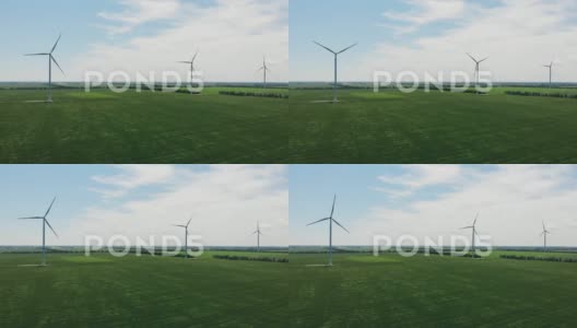 风力涡轮机在蓝天和草地上高清在线视频素材下载
