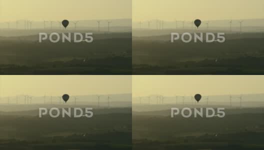 背景是风力涡轮机的热气球高清在线视频素材下载