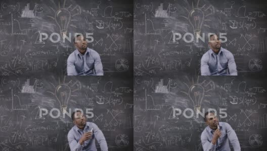 坐在黑板前思数学公式的男人高清在线视频素材下载