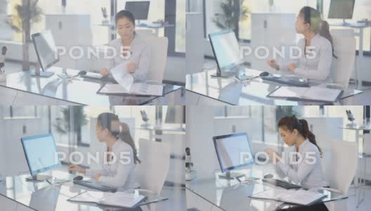 正坐在办公桌前工作的女人高清在线视频素材下载
