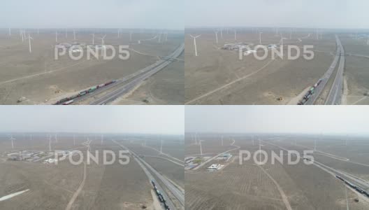 戈壁沙漠的公路、卡车和风力涡轮机高清在线视频素材下载