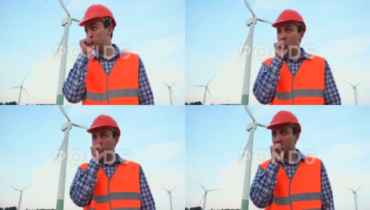 风力涡轮机发电厂的工程师打喷嚏。风电场和工人高清在线视频素材下载