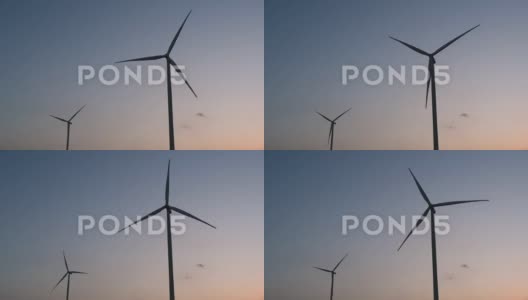 能源，风力涡轮机在日落时分的蓝天中的剪影，干净能源高清在线视频素材下载