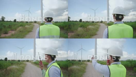亚洲男性工程师在风力涡轮机中工作的后视图高清在线视频素材下载