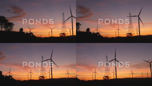 水平轴风力涡轮机，风力涡轮机和输电线路在日落时的景象高清在线视频素材下载