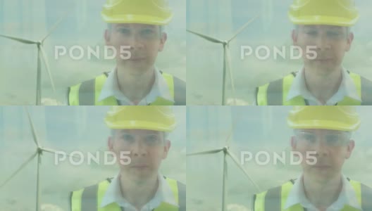 一个能源工作者在风力涡轮机前的反思高清在线视频素材下载