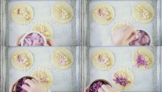 在白玉米饼上准备新鲜的鳕鱼和紫甘蓝玉米卷高清在线视频素材下载