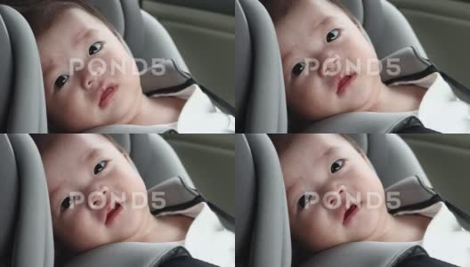 本地生活方式亚洲中国婴儿男孩在儿童安全汽车座椅高清在线视频素材下载