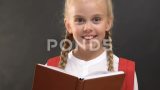 快乐的女生看书，对着黑板对着镜头微笑高清在线视频素材下载
